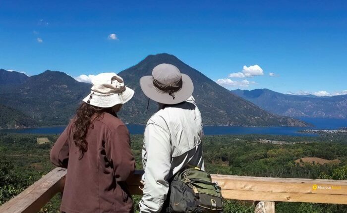 Couple enjoying a tranquil moment at the pristine Lake Atitlan during the Guatemala Nature Retreat tour.