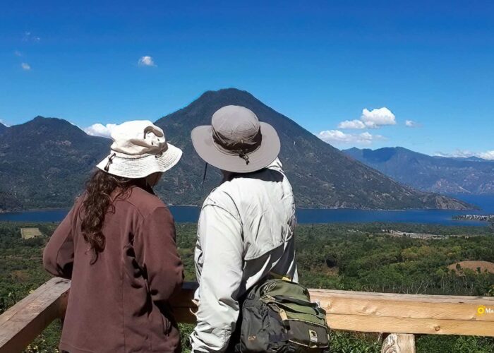 Couple enjoying a tranquil moment at the pristine Lake Atitlan during the Guatemala Nature Retreat tour.
