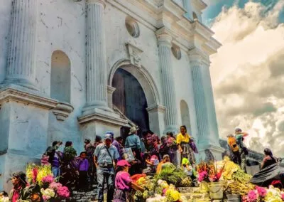 The Chichicastenango church, filled with flower vendors, is frozen in a picture.