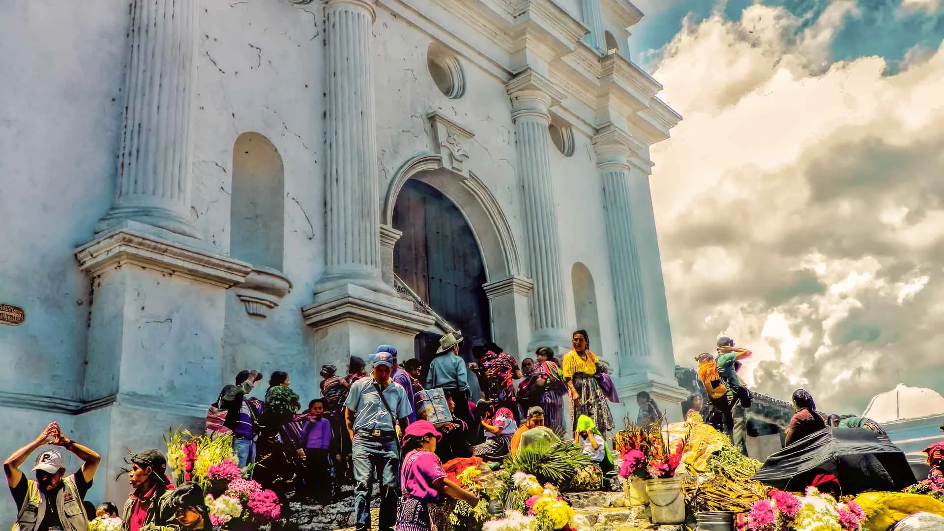 The Chichicastenango church, filled with flower vendors, is frozen in a picture.