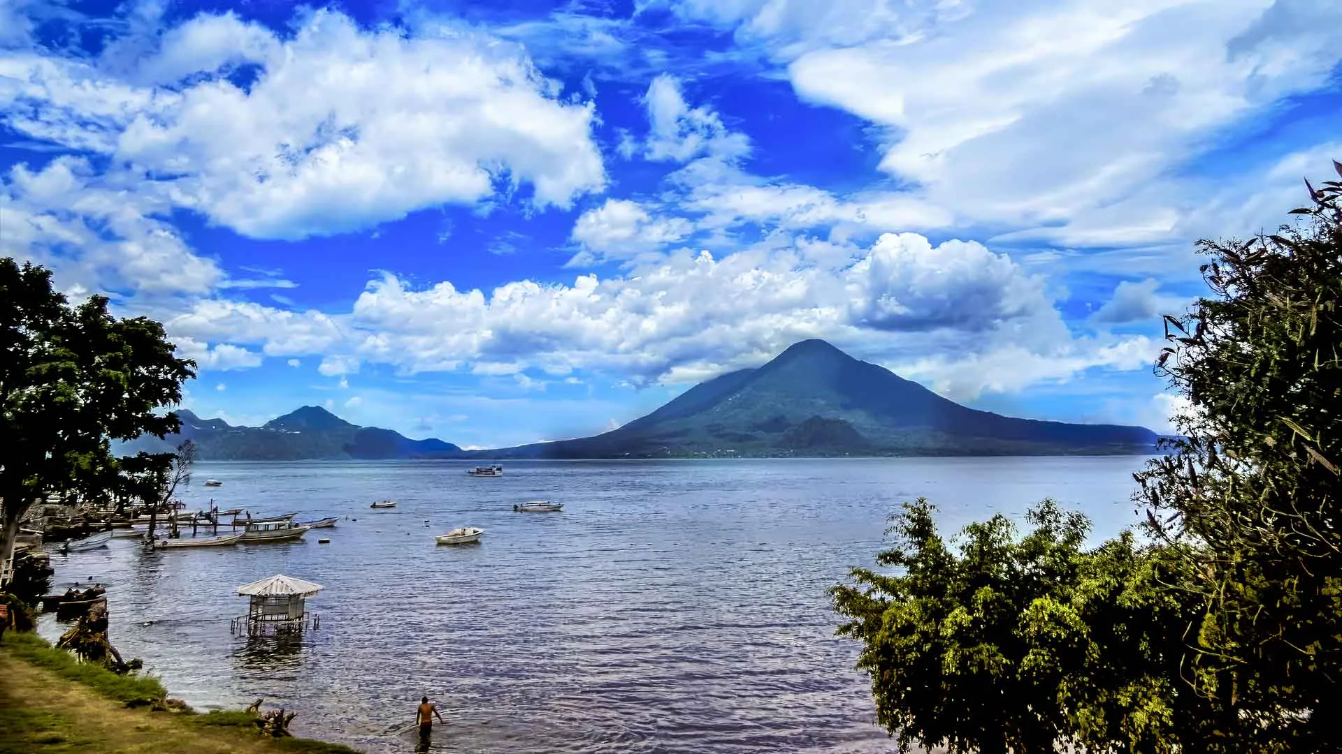 This picture showcases the serene landscape with imponent Lake Atitlan volcanoes, a highlight of our Guatemala Tour.