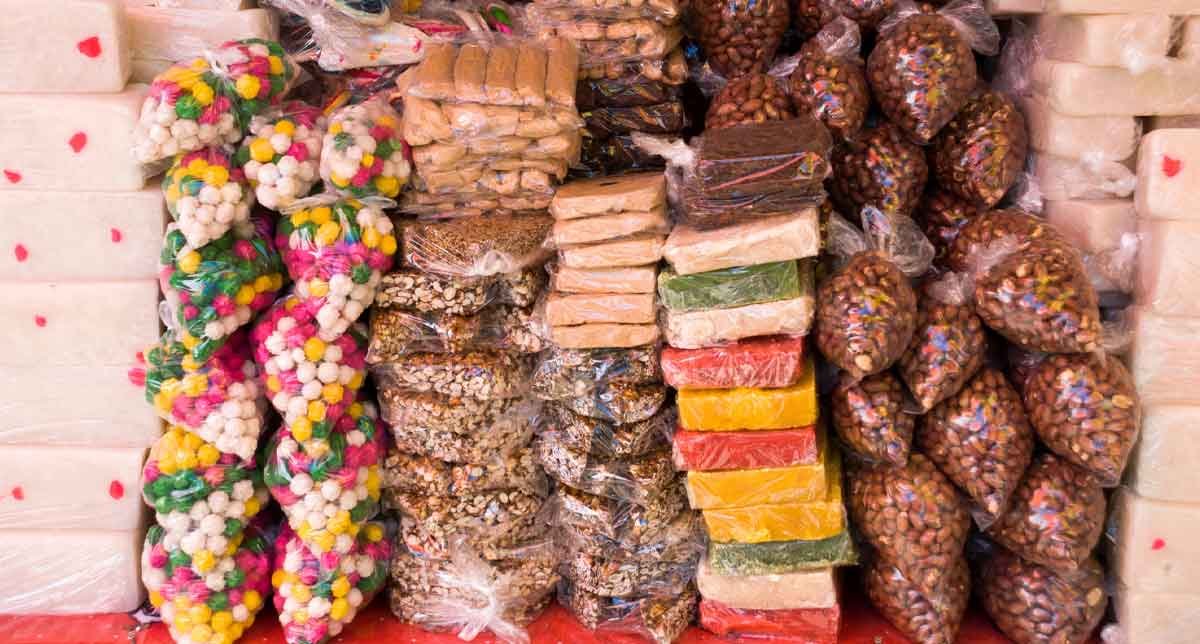 A colorful assortment of traditional Guatemalan candies and candied peanuts, showcasing local flavors like coconut, tamarind, and roasted sugar in handcrafted sweets.