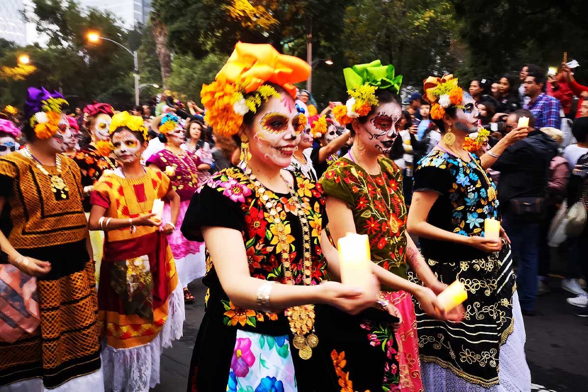 Katrinas Catrina parade in Mexico City during Día de Muertos, a highlight of October cultural festivals in Central America featuring traditional costumes and vibrant celebrations.