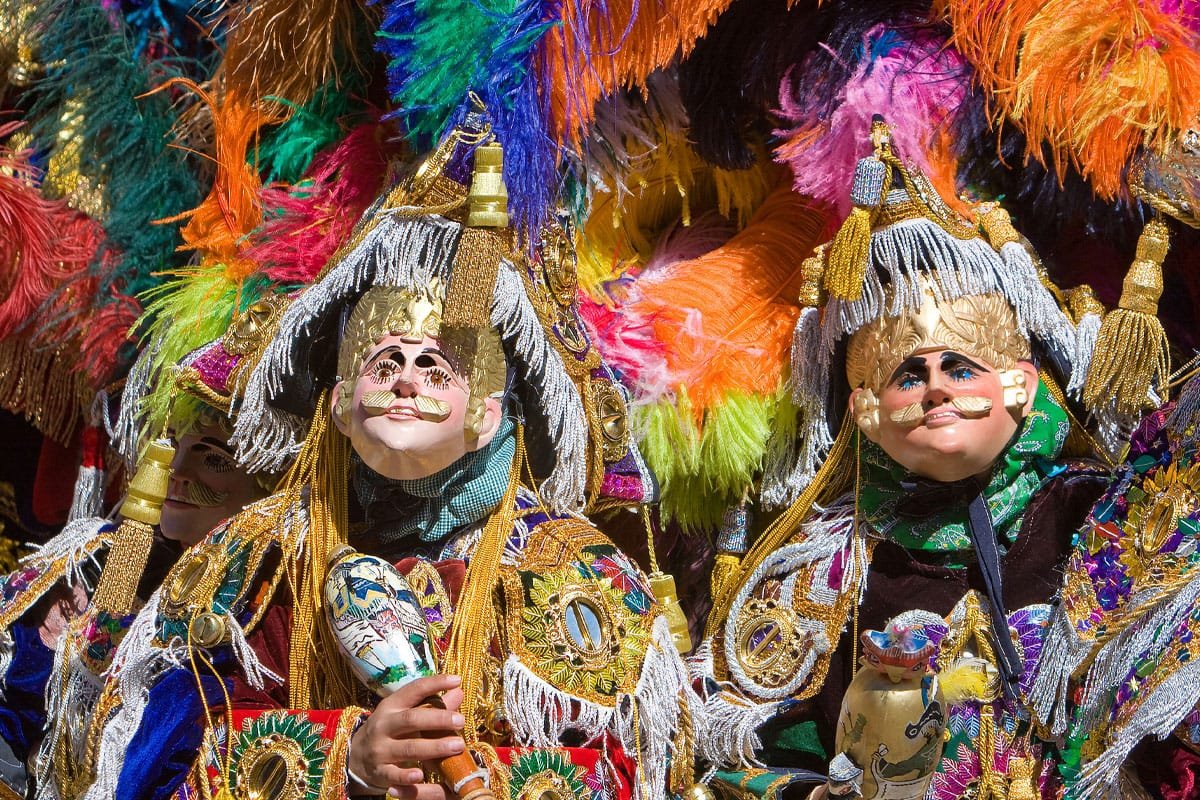 Maya-dancers Maya dancers in traditional masks and colorful feathered costumes performing at a Guatemalan fair during October cultural festivals in Central America.