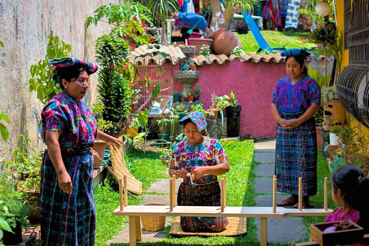 Textiles-workshop | martsam Guatemala cultural tours 2026 – Atitlán Mayan women leading a hands-on textile weaving workshop using traditional backstrap looms.