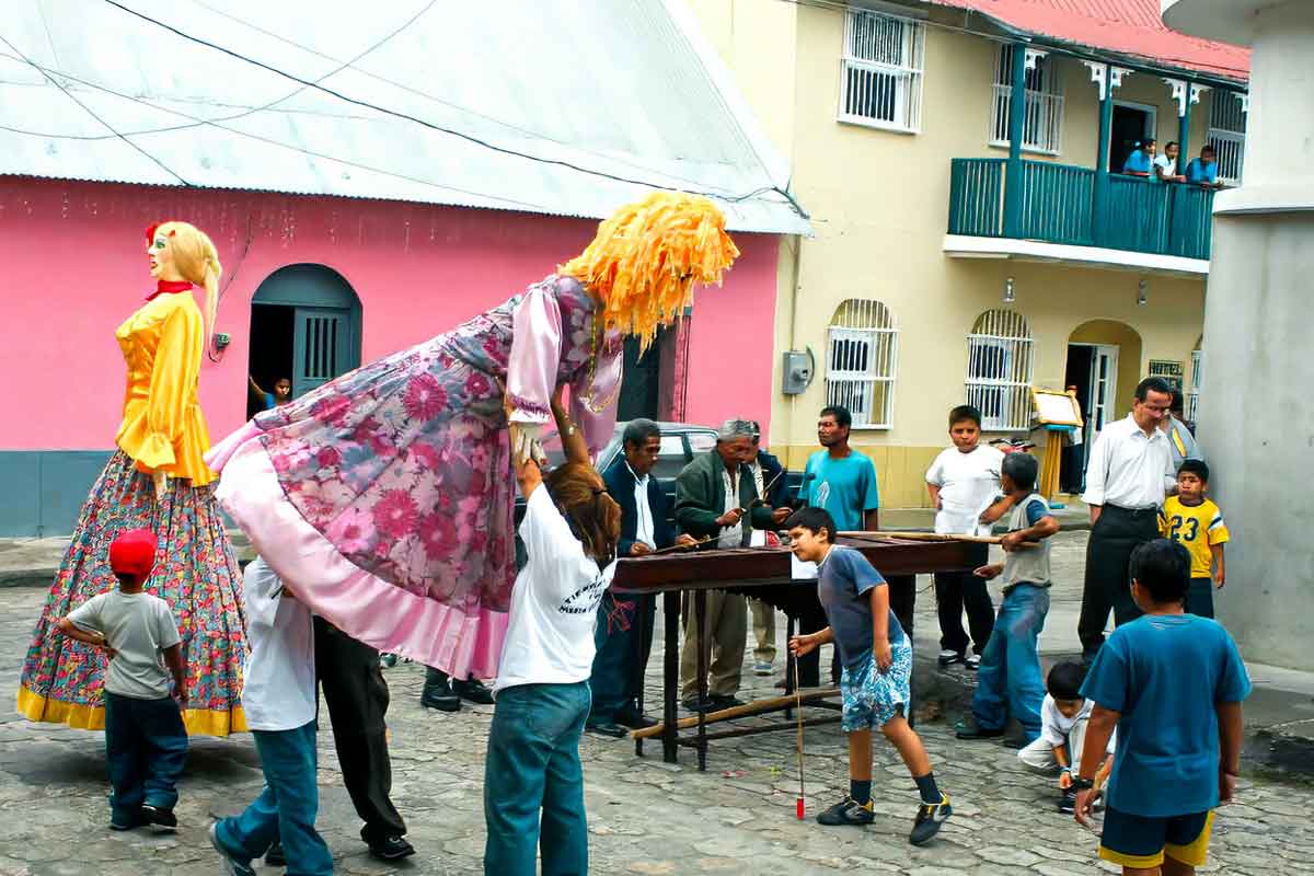Local celebration in the streets of Flores Island with marimba music, La Chatona dances, and community gathering during private cultural tours Guatemala experiences