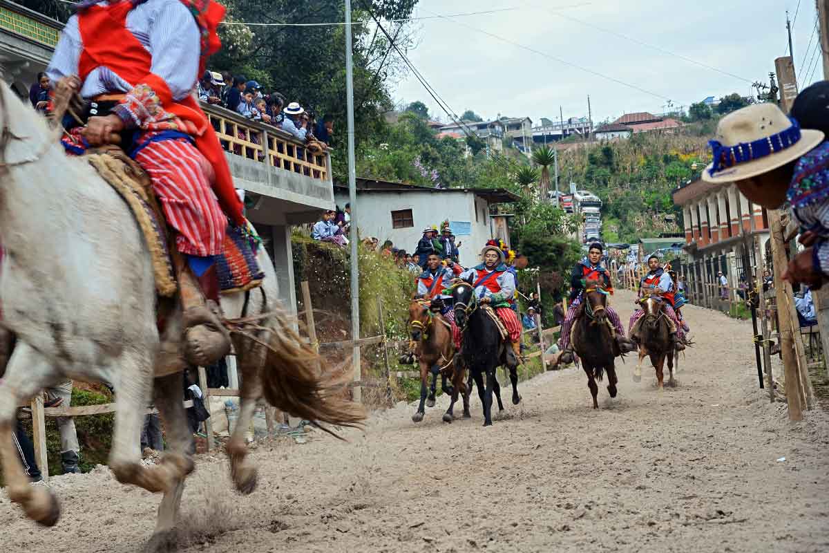 Colorful Día de los Muertos horse race in Todos Santos Cuchumatán with Maya riders in traditional dress, celebrated as part of Guatemala’s living traditions during private cultural tours Guatemala journeys