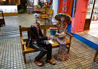 Merida-markets-tour | martsam travel Colorful handcrafted skeleton figures at a Mérida market during a Private Yucatan Tour.