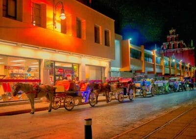 Mérida Vacation Package evening view of traditional horse-drawn carriages in central Mérida