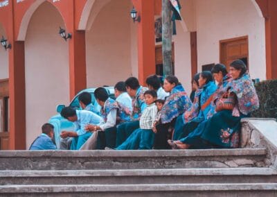 Residents wearing traditional floral clothing gathered in Zinacantán during a Chiapas Cultural Tour.
