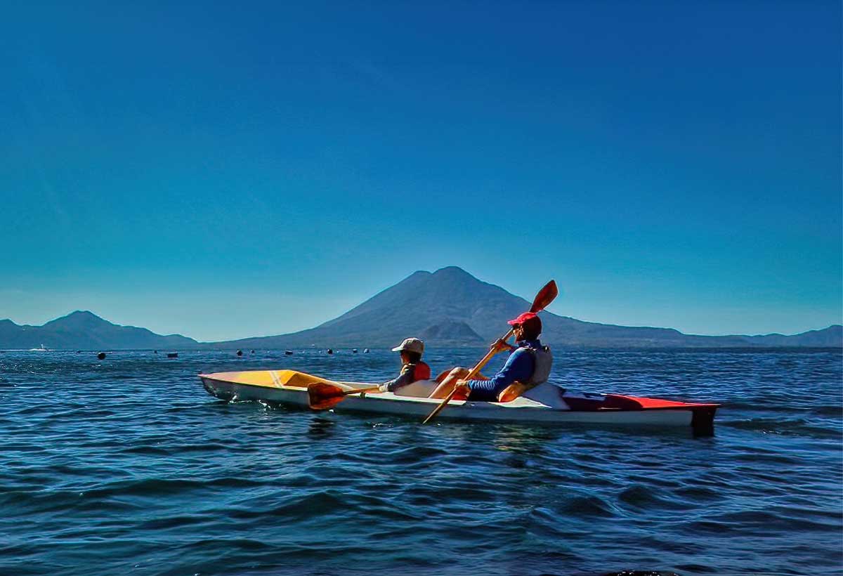 Kayaking-lake-atitlan | martsam travel Travelers kayaking on Lake Atitlán with the surrounding volcanoes in the background.