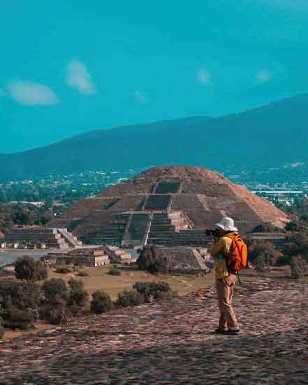 Photographer overlooking the Pyramid of the Moon and Avenue of the Dead at Teotihuacán during one of our Mexico Tour Packages.