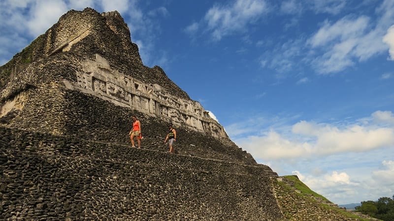 Xunantunich-maya-site | martsam travel Xunantunich: Travelers climbing El Castillo at Xunantunich Maya site during Vacation Packages for Belize.
