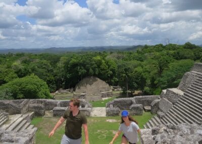 Travelers exploring Caracol Maya site above the rainforest during a Belize adventure tour