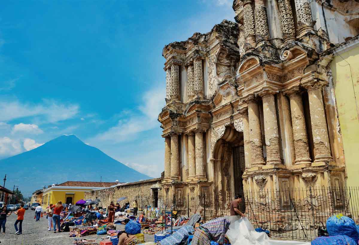El-carmen-church-market-antigua-guatemala | martsam travel El Carmen Church ruins and street market in Antigua Guatemala, with Agua Volcano in the background.