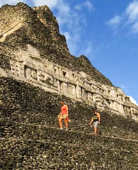 El-castillo-frieze-xunantunich | martsam travel Two women walking below the great stucco frieze on El Castillo at Xunantunich.