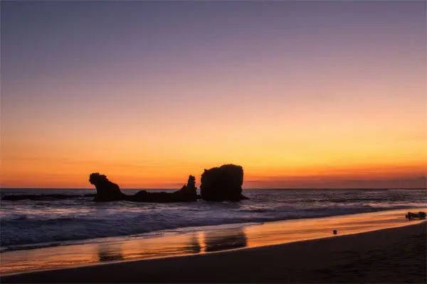Pacific-coast-el-salvador | martsam travel Sunset over a Pacific beach with offshore rock formations in El Salvador.