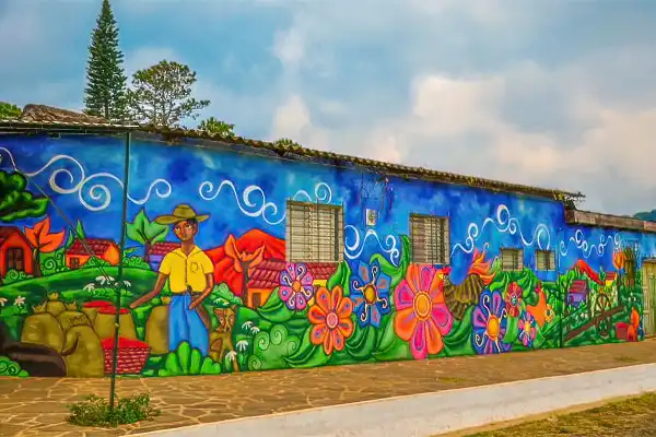 Ruta-de-las-flores-el-salvador | martsam travel Colorful mural depicting flowers and rural life along the Ruta de las Flores in El Salvador.