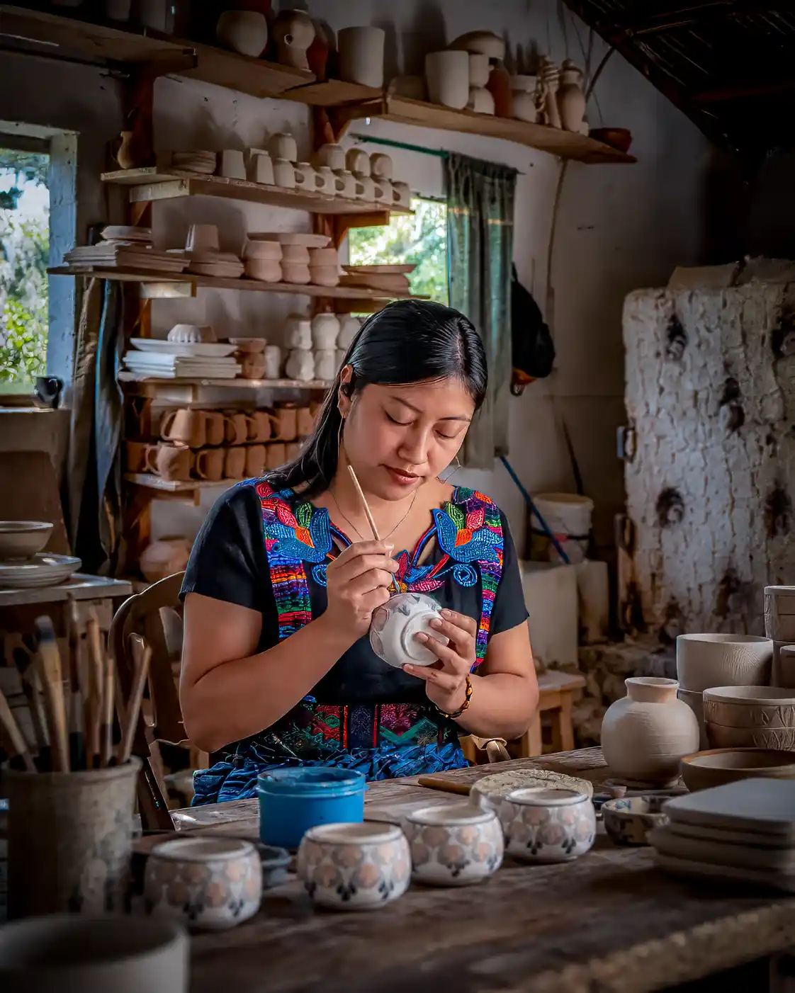 Maya-potter-painting-ceramics-in-her-studio | martsam travel Guatemala cultural tours hands-on pottery workshop with a Maya artisan in San Antonio Palopó, Lake Atitlán.