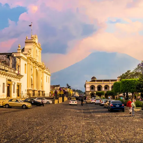 Incentive-travel-guatemala-antigua-colonial-street | martsam travel Incentive travel in Guatemala featuring a colonial street scene in Antigua Guatemala with a volcano in the background.